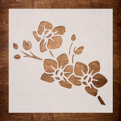 Floral stencil on a white sheet with a wooden background