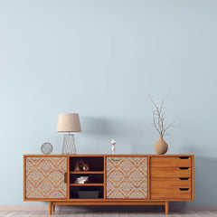 Wooden sideboard with decorative elements against a light blue wall