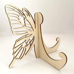 Wooden letter 'K' with butterfly wings on a white background