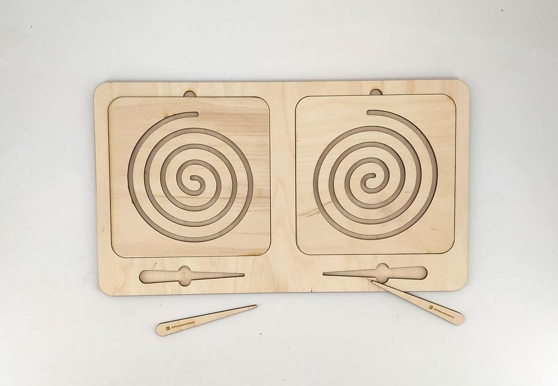 Wooden puzzle with spiral designs and wooden tools on a white background