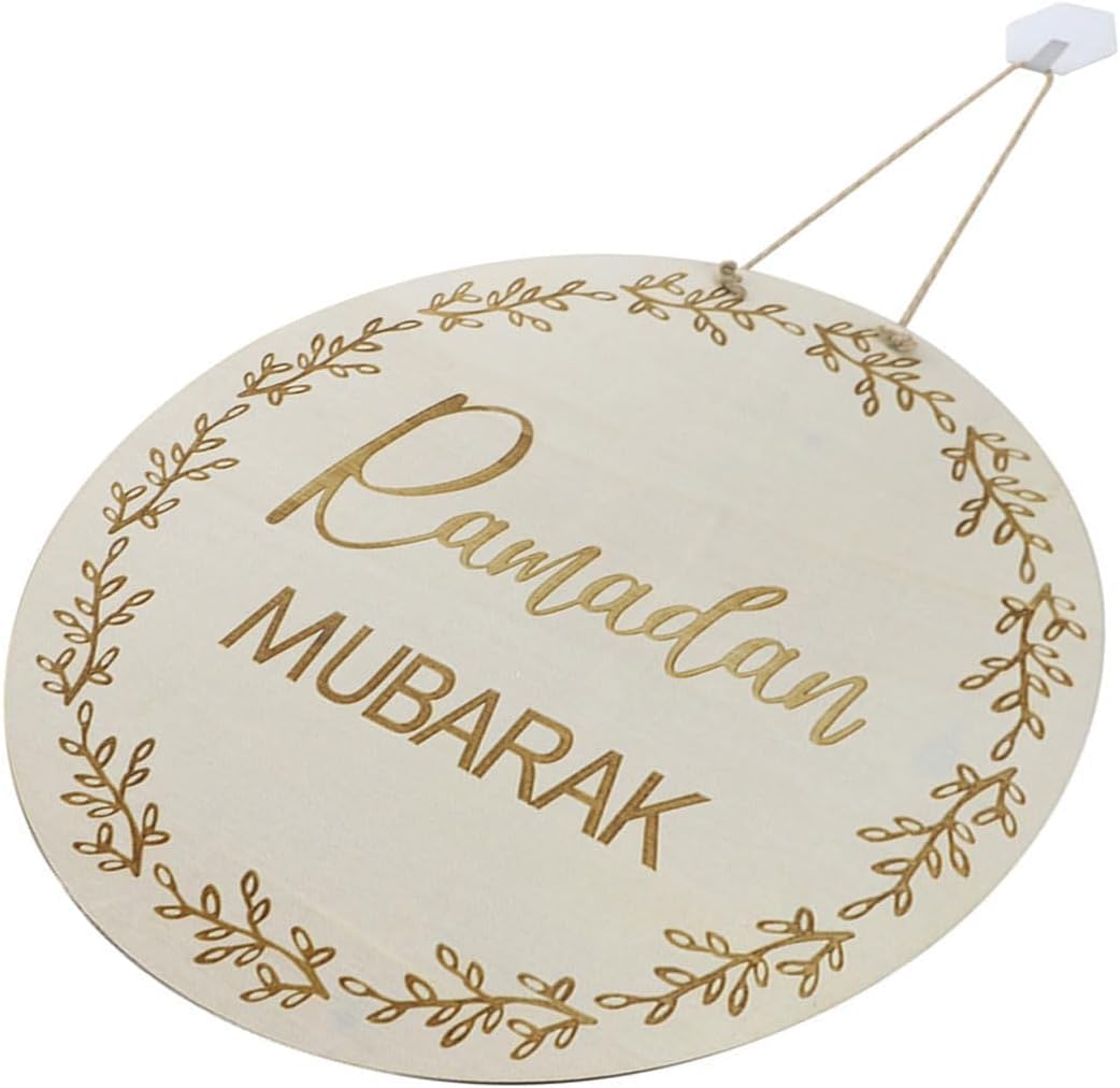 Round wooden sign with 'Ramadan Mubarak' text and gold leaf designs on a white background