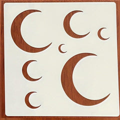 Wooden moon phase stencils on a white background