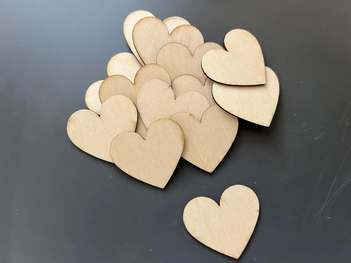 Stack of wooden heart shapes on a dark surface