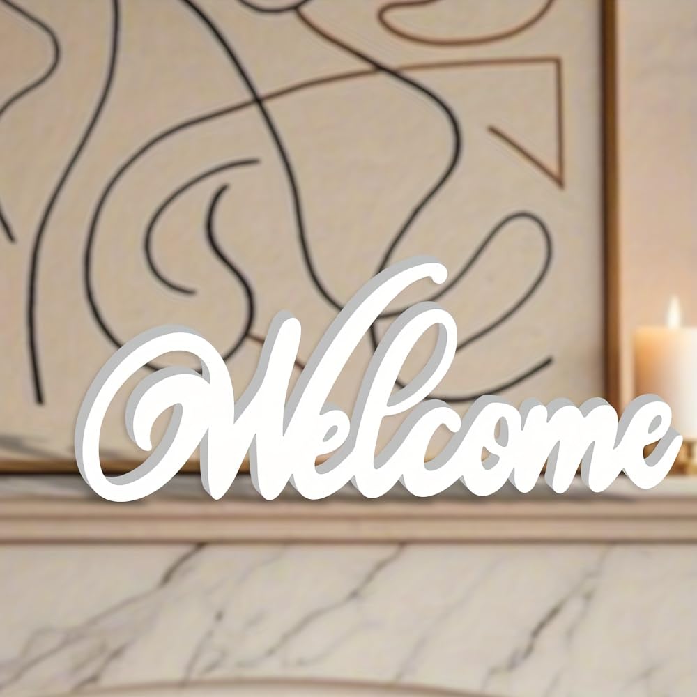 White 'Welcome' sign on a marble surface with abstract wall art in the background