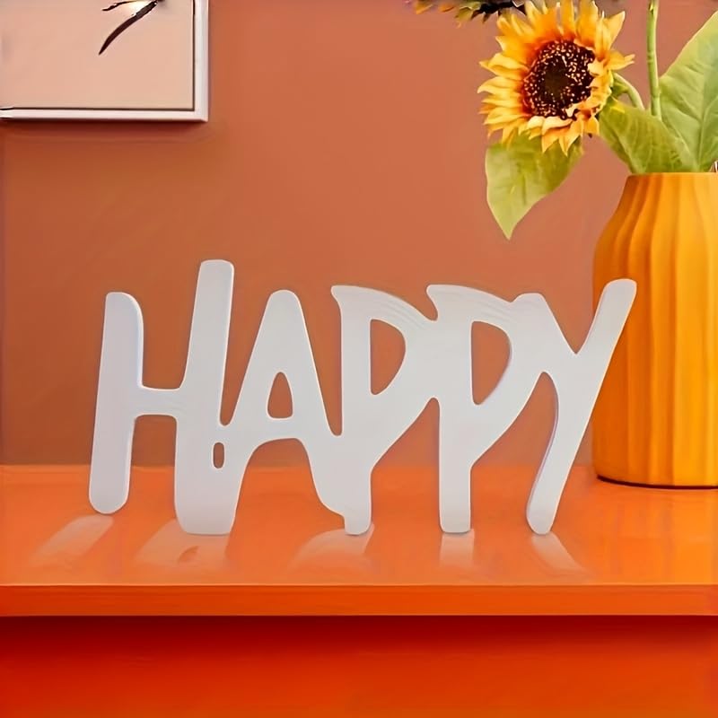 Decorative word 'HAPPY' on an orange surface with a sunflower in the background.
