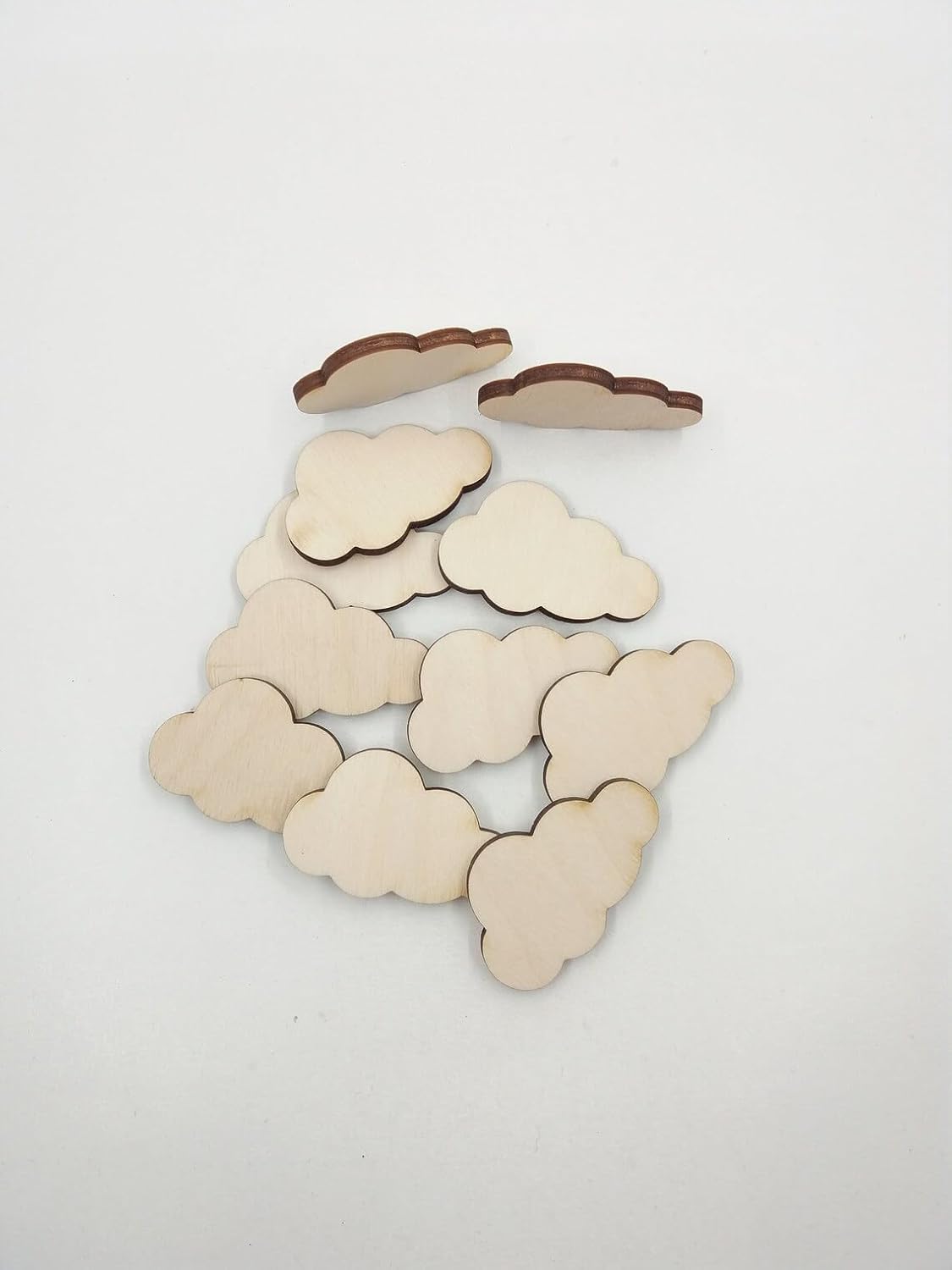 Cloud-shaped wooden cutouts on a white background