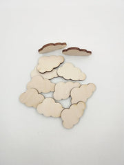 Cloud-shaped wooden cutouts on a white background