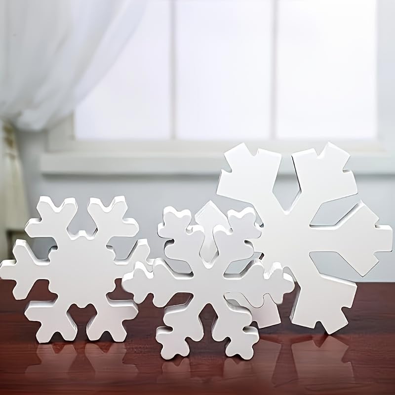 White snowflake decorations on a wooden surface with a blurred background