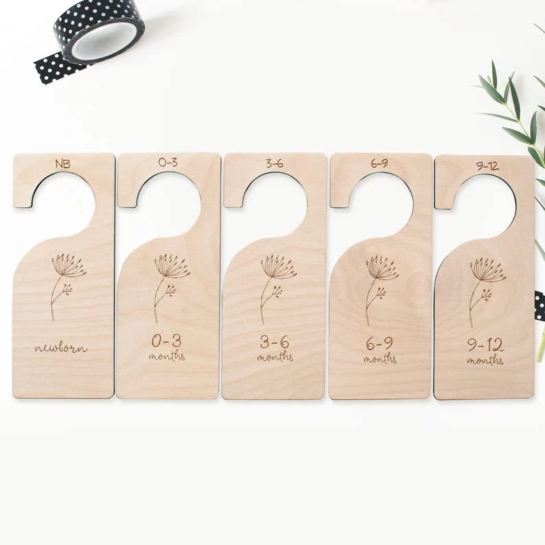 Set of wooden baby size dividers with engraved measurements on a white background.