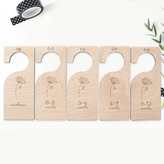 Set of wooden baby size dividers with engraved measurements on a white background.