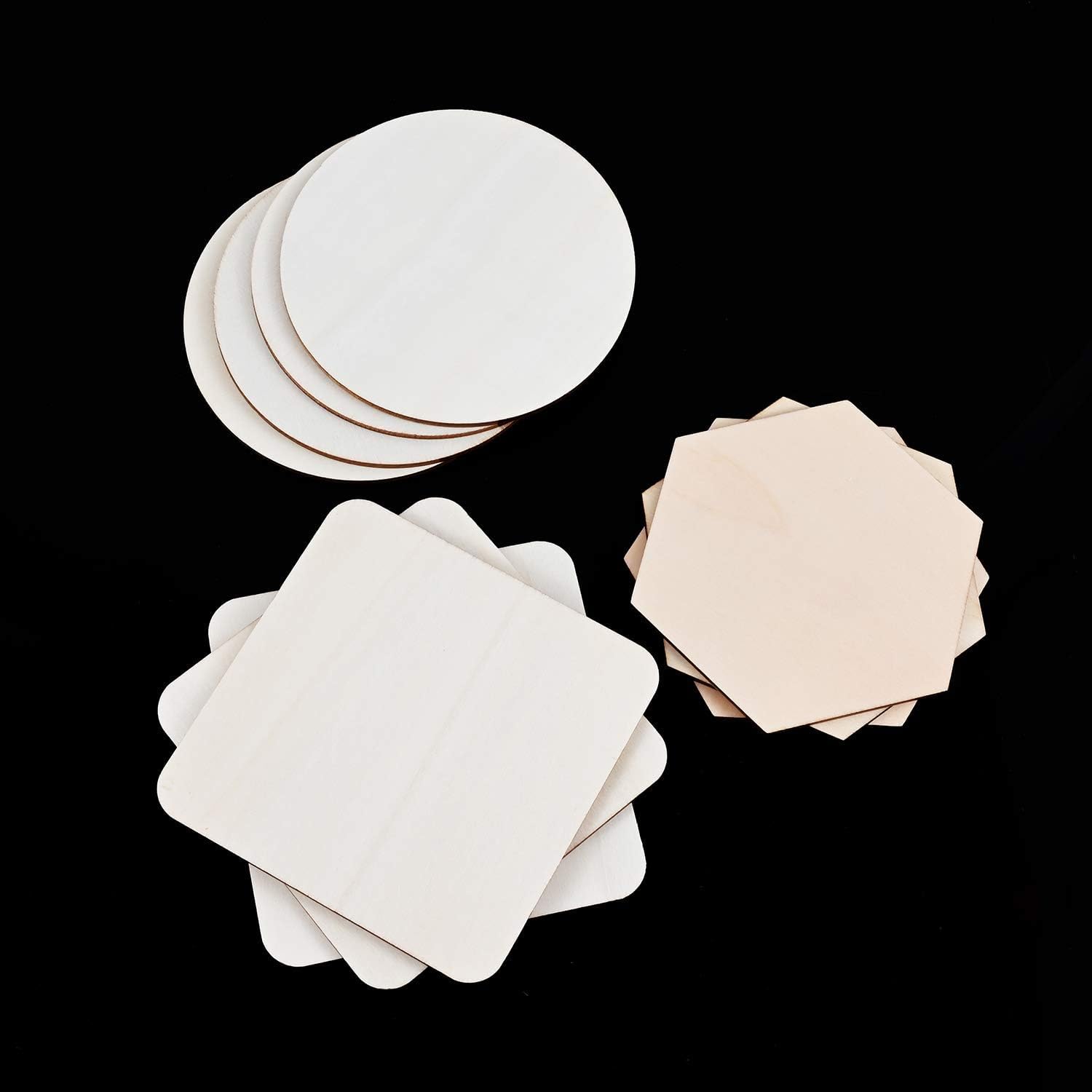 Set of white and beige round paper coasters on a black background