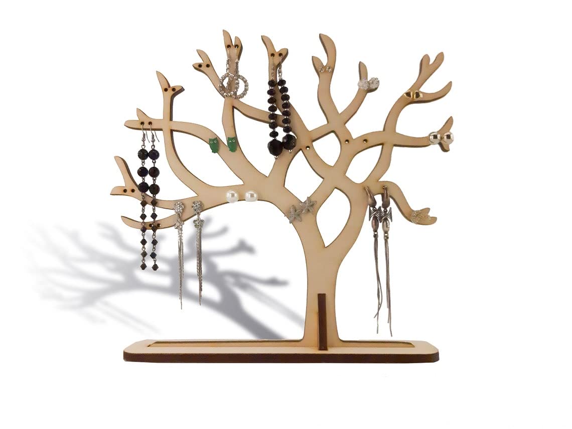 Wooden jewelry tree with hanging earrings on a white background