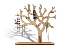 Wooden jewelry tree with hanging earrings on a white background