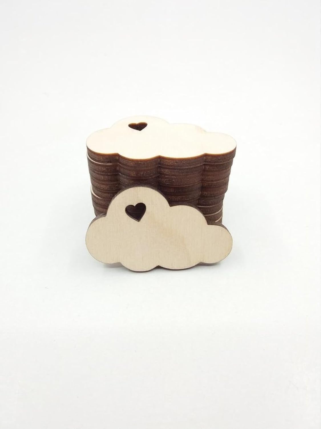 Wooden cloud-shaped object with a heart cutout on a white background
