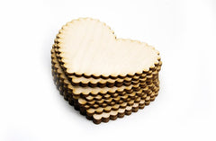 Stack of heart-shaped wooden coasters on a white background