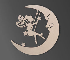Decorative cutout of a fairy on a crescent moon with stars against a dark background