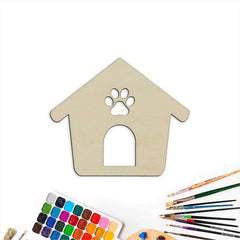 Wooden doghouse-shaped craft with a paw print cutout, watercolor set, and paintbrushes on a white background