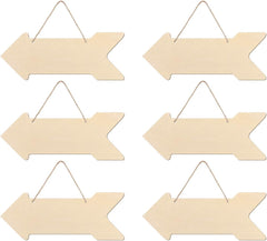 Set of six wooden arrow-shaped signs with hanging strings on a white background