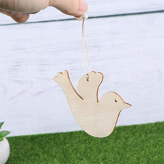 Wooden bird ornament hanging from a string with a blurred background
