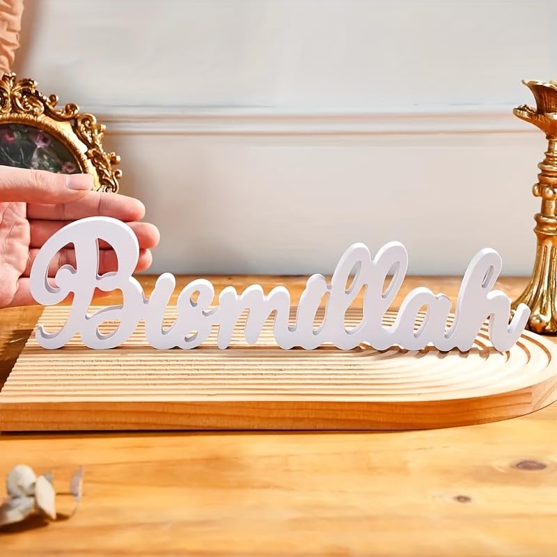 Wooden 'Bismillah' sign on a wooden surface with decorative items in the background.