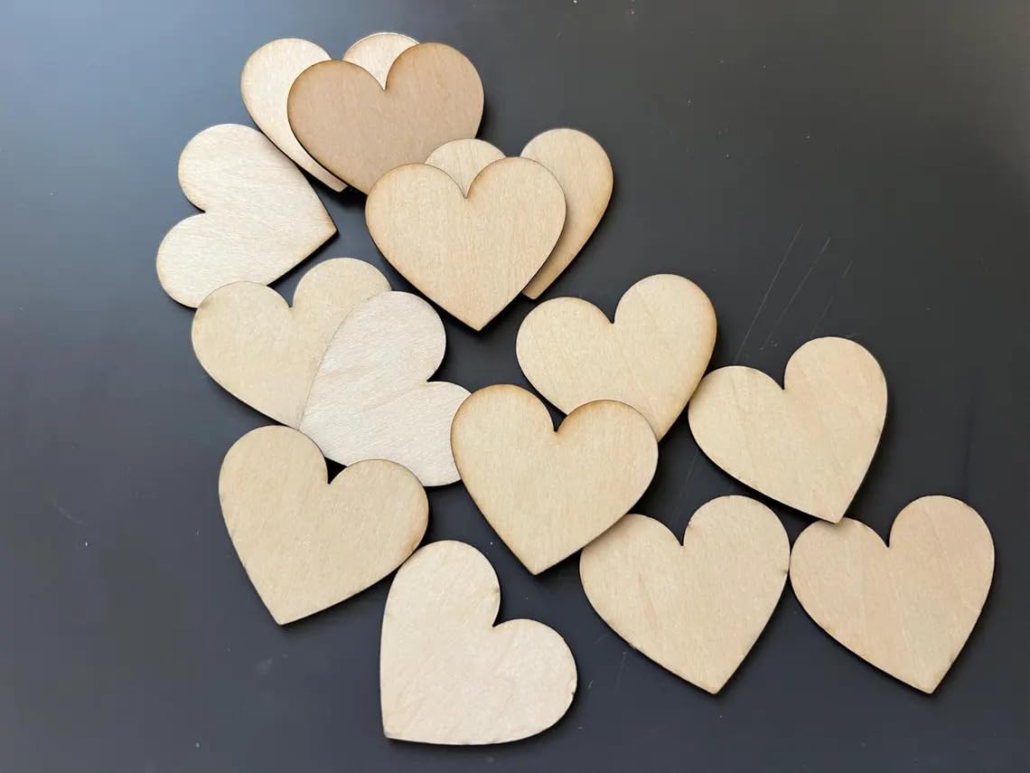 Heart-shaped wooden cutouts in various shades of beige on a dark background