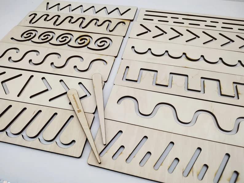 Wooden templates with cut-out patterns on a white background