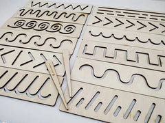 Wooden templates with cut-out patterns on a white background