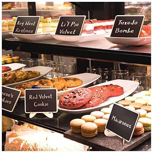 Display of various pastries with labeled signs on a counter.