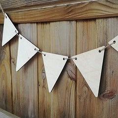 White triangle-shaped bunting flags hanging against a wooden background