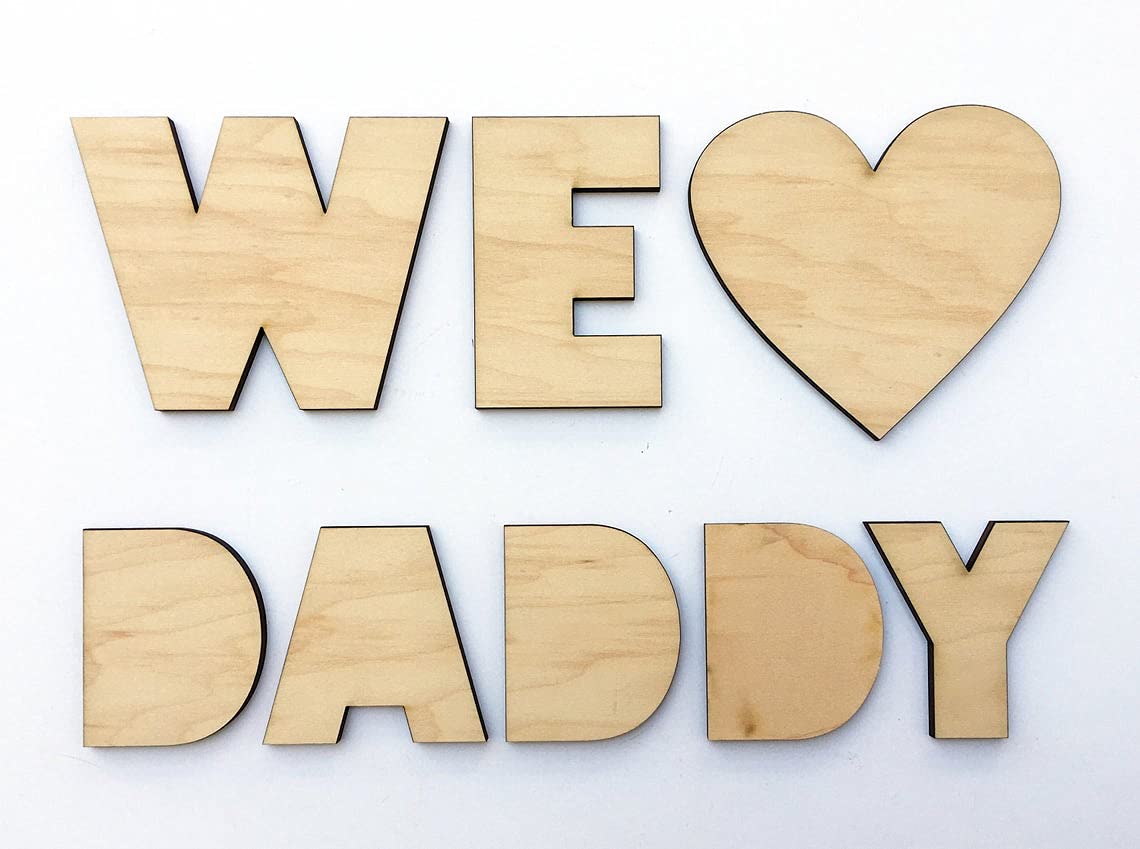 Wooden letters spelling 'WE LOVE DADDY' on a white background