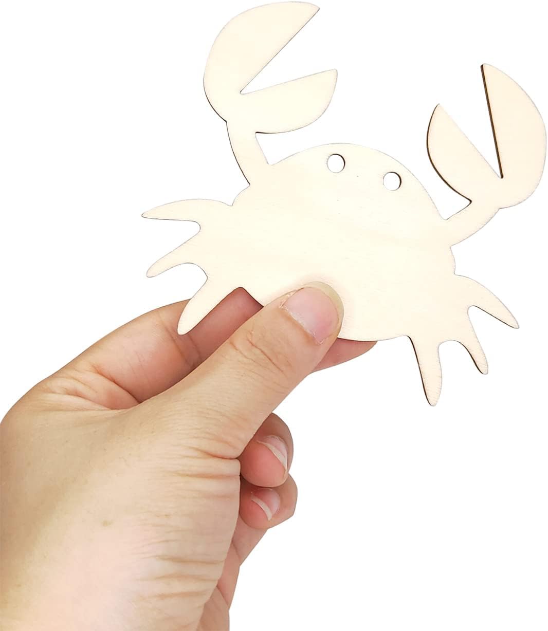 Hand holding a beige crab-shaped bottle opener against a white background