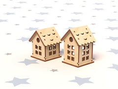 Two wooden house-shaped objects on a white background with star patterns