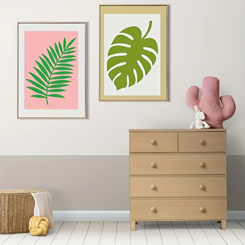 Room interior with framed leaf prints, a dresser, and decorative items.
