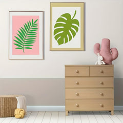 Room interior with framed leaf prints, a dresser, and decorative items.