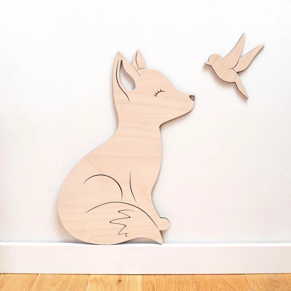 Wooden fox and bird wall decorations on a white background