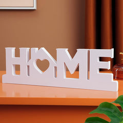 Decorative sign with 'HOME' letters on a wooden surface