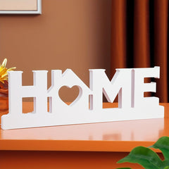 Decorative sign with 'HOME' and heart design on a wooden surface.