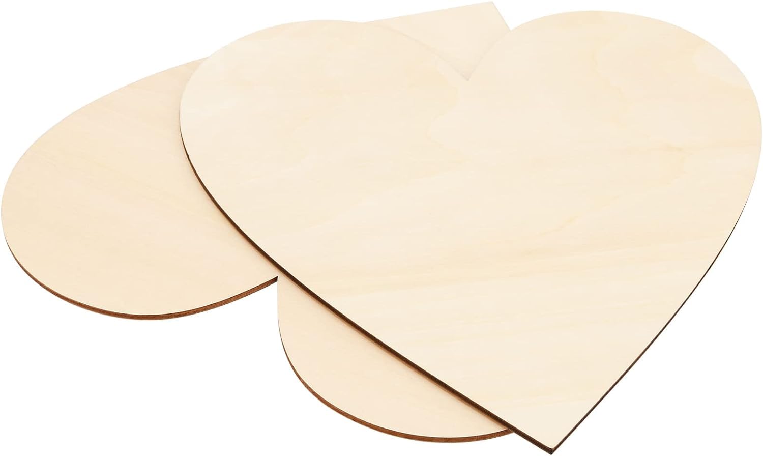 Three heart-shaped wooden cutouts on a white background