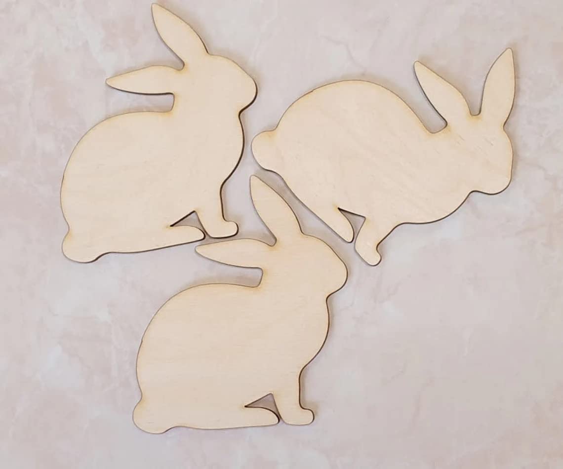 Three wooden rabbit shapes on a light background