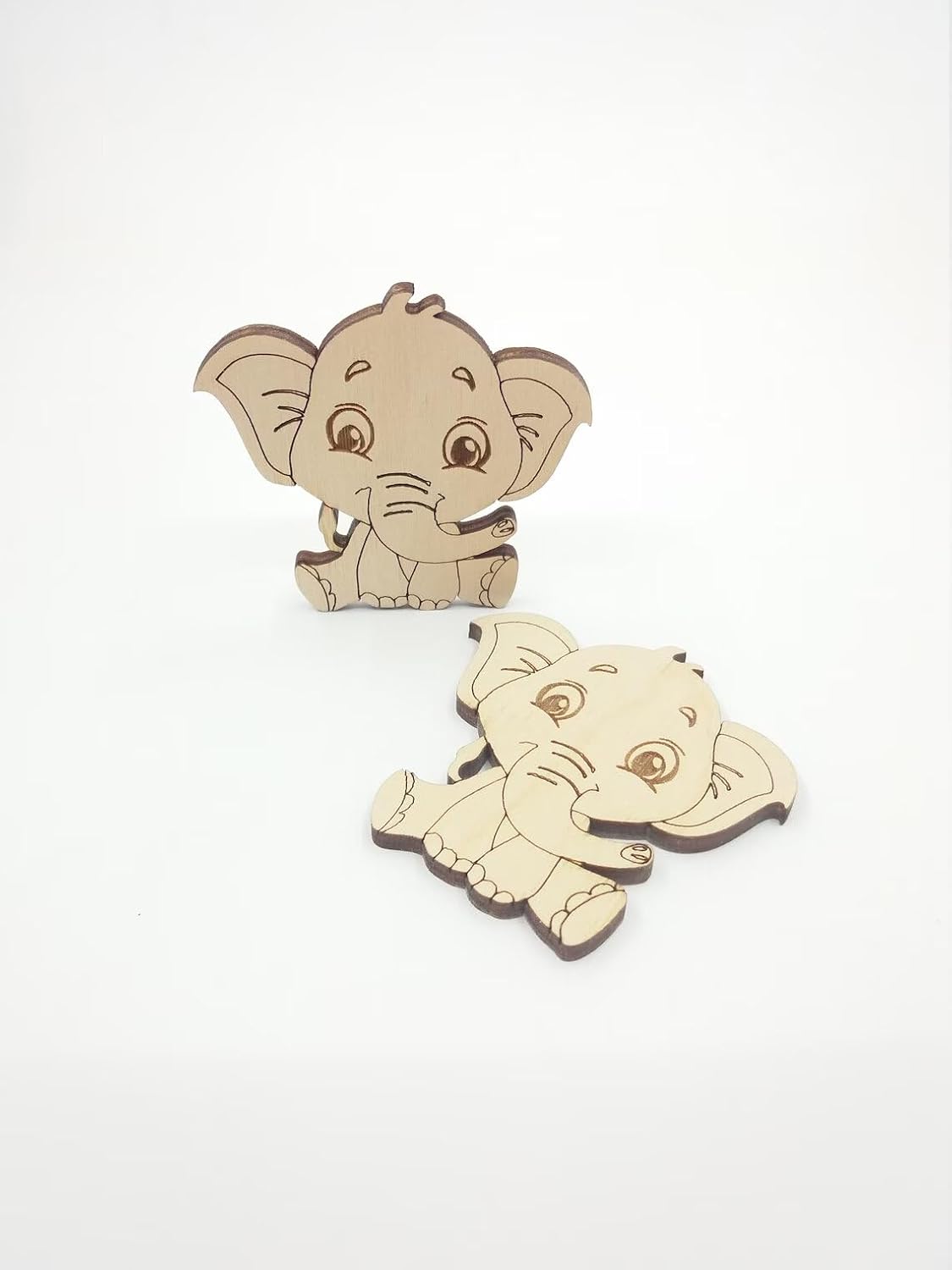 Two wooden elephant toys on a white background
