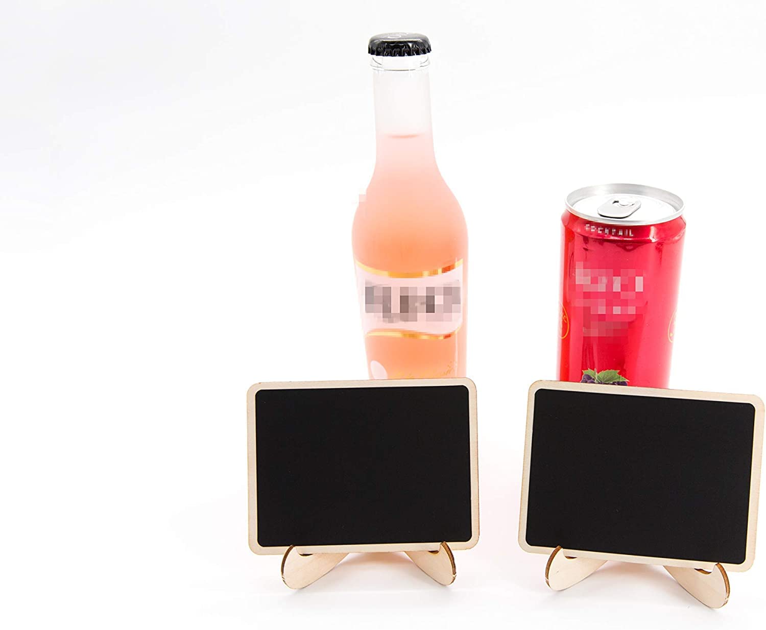 Two small blackboard signs on stands with a bottle and can in the background.