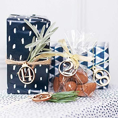 Decorative gift with a plant, small bag of cookies, and gold number '14' charm on a white background.