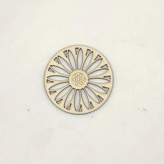 Decorative metal trivet with sunflower design on a white background
