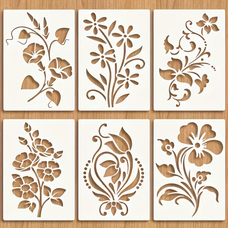 Set of six floral stencils on a wooden surface