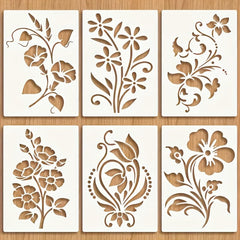Set of six floral stencils on a wooden surface