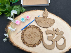 Wooden cutouts of symbols on a wooden surface with flowers and a box in the background