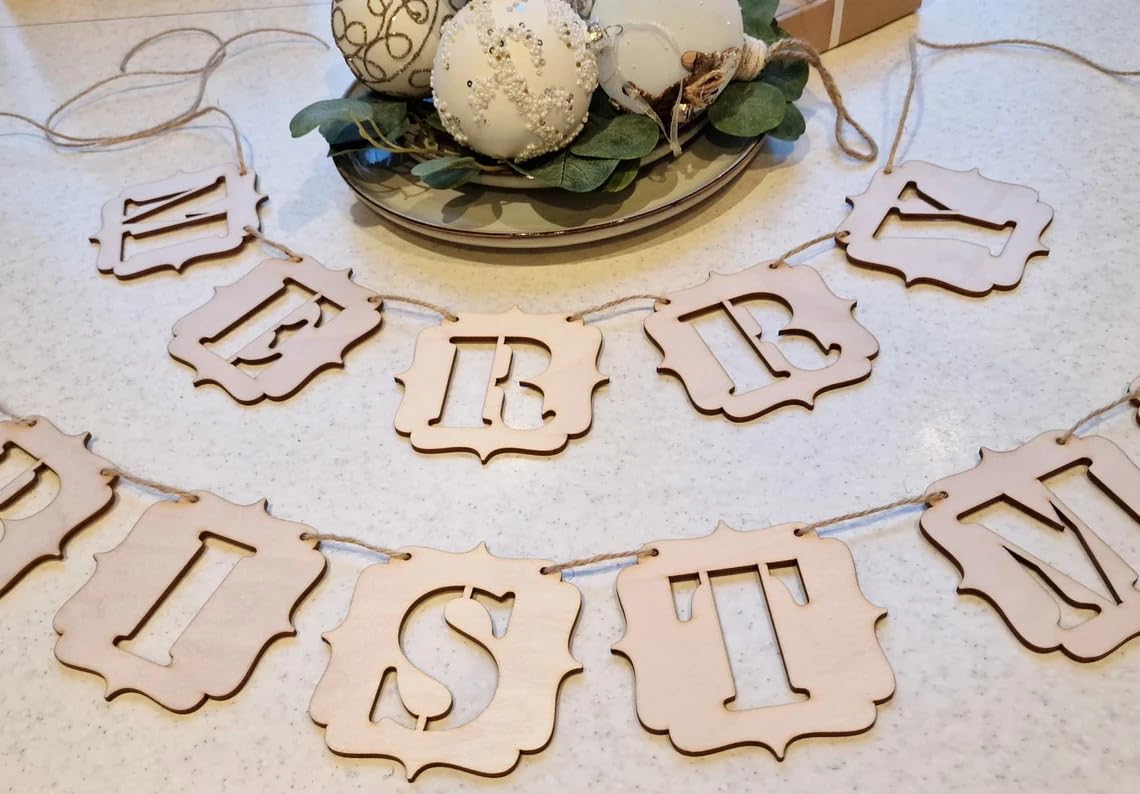 Wooden letter banner with decorative items on a light background