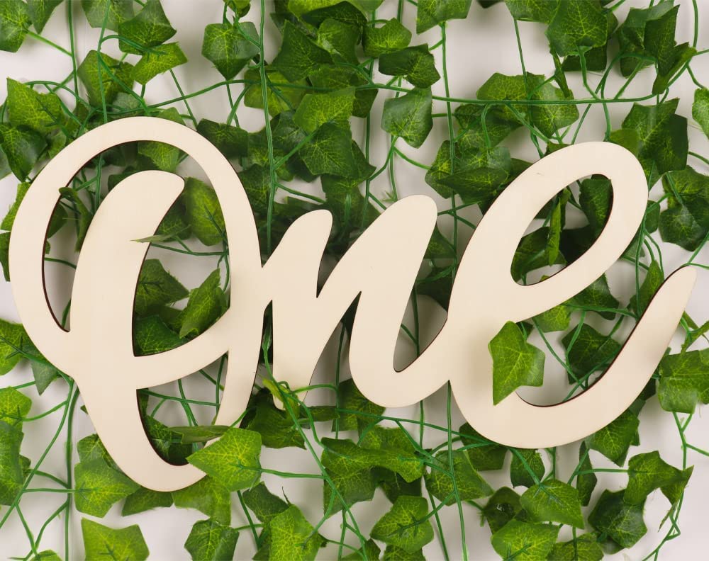 Wooden letter 'One' on a background of green leaves