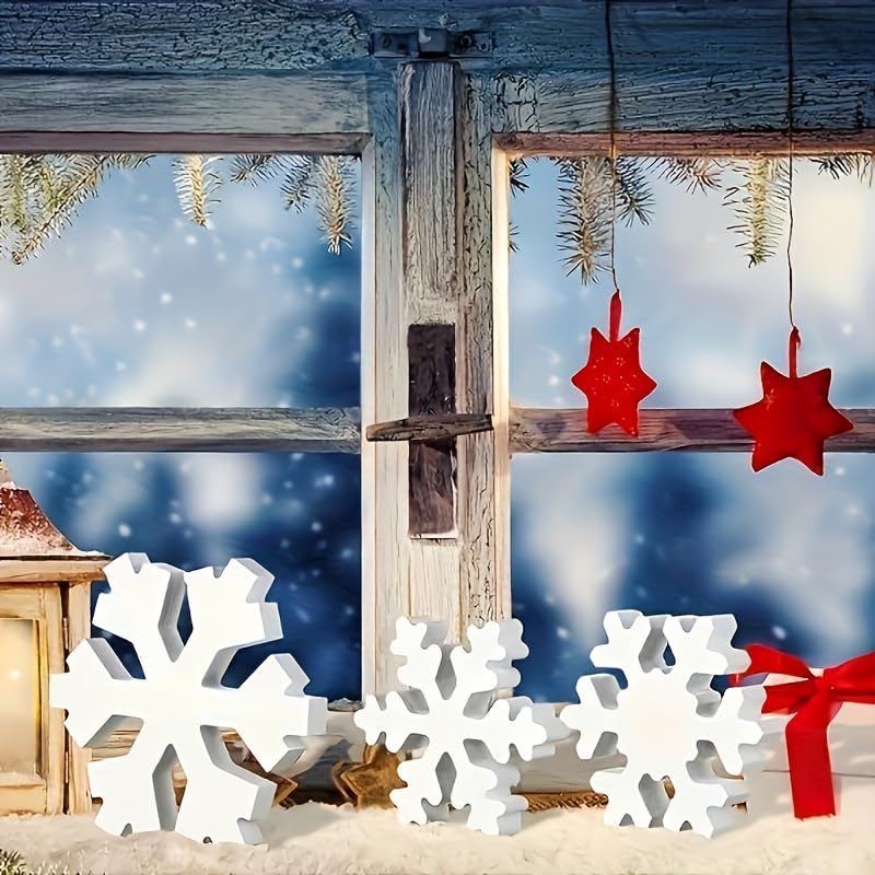 Decorative window with Christmas decorations, including red stars and white snowflakes, against a snowy landscape.