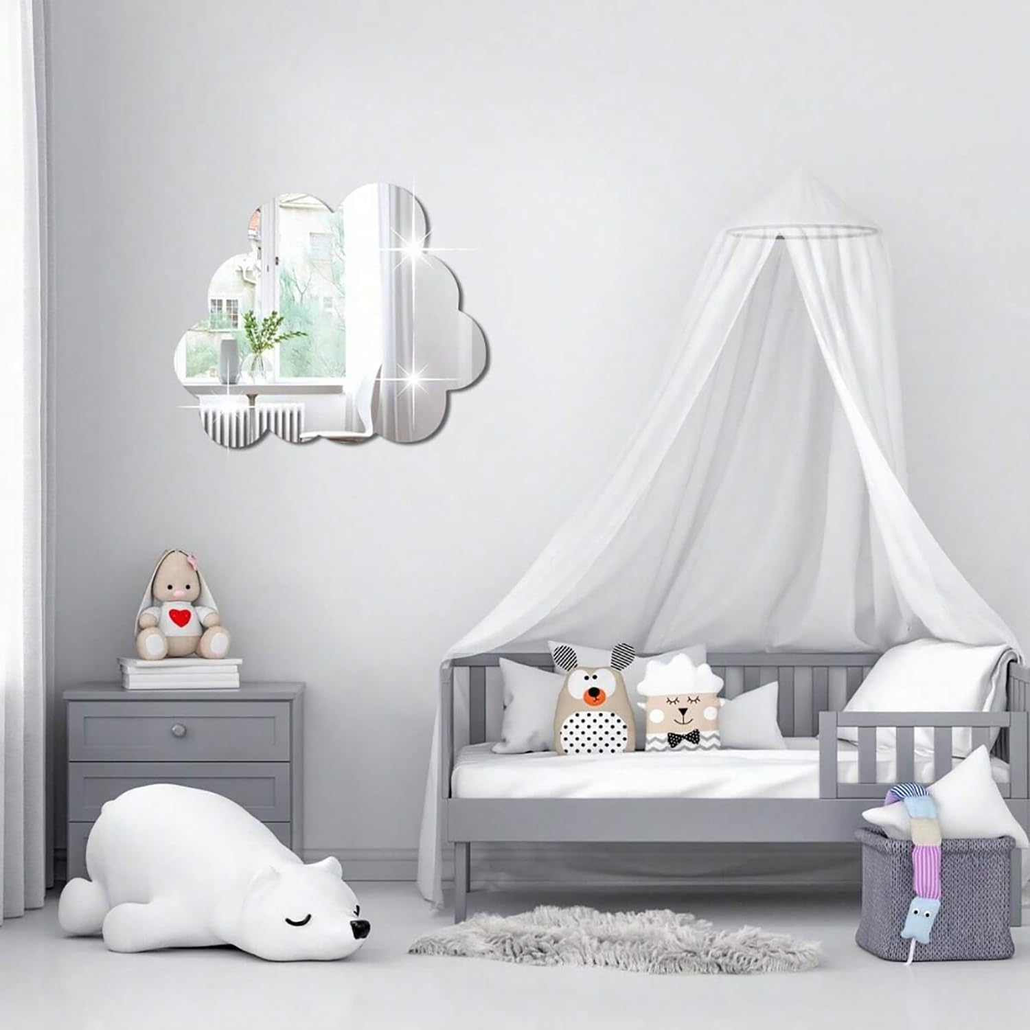 Children's bedroom with a gray crib, stuffed animals, and a decorative mirror.